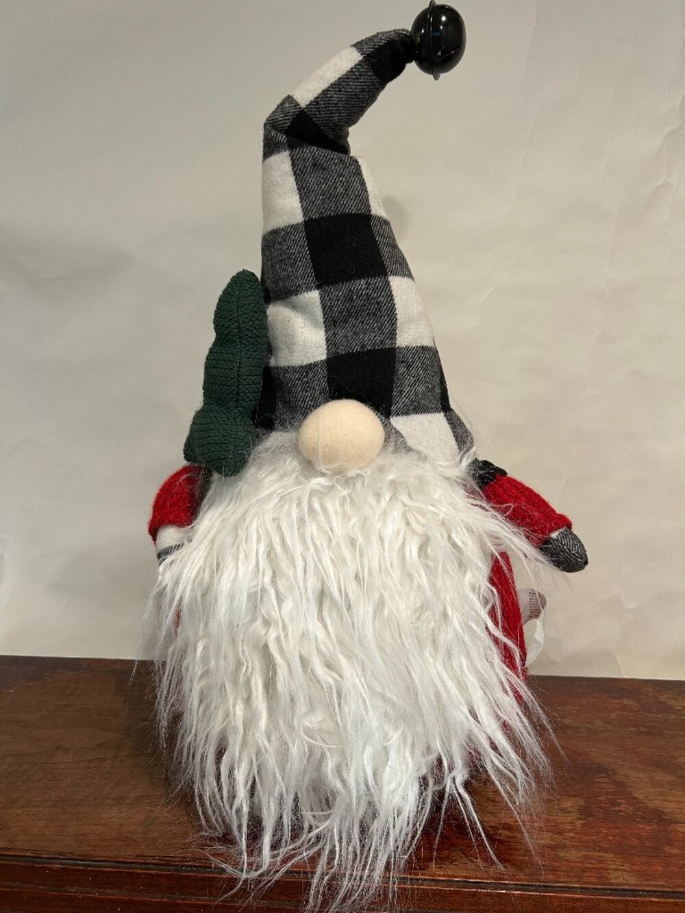 Christmas Holiday Gnome with bean bag base and bell on cap holding a tree